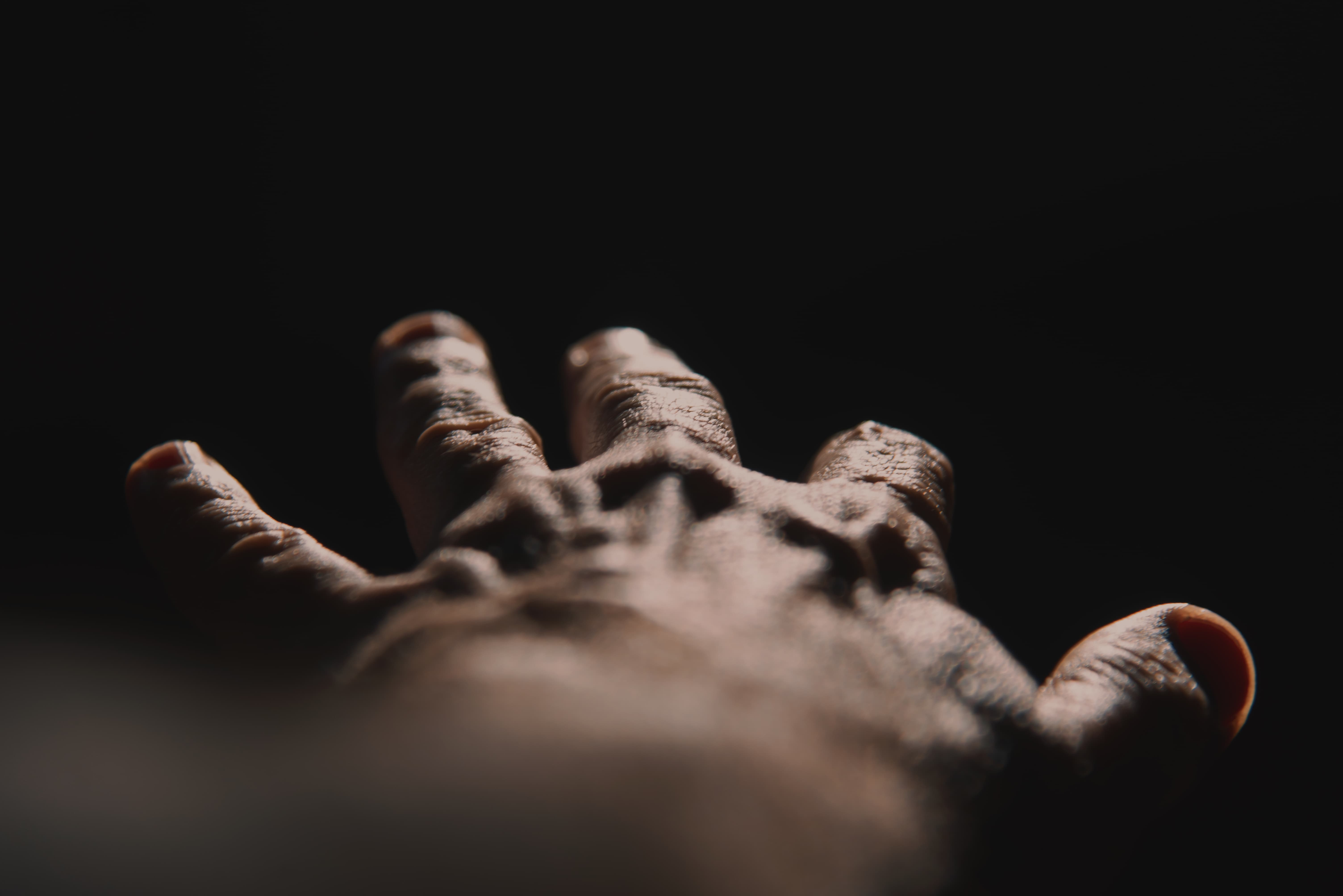 Eine Männerhand mit in die Weite gestreckten Fingern.